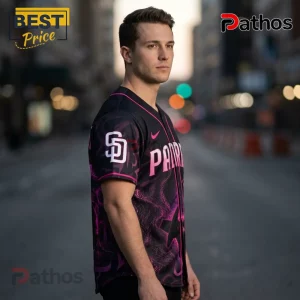 San Diego Padres Saja Boys KPop Demon Hunters Pink Baseball Jersey 2 Man wearing a black San Diego Padres baseball jersey with pink lettering and SD logo against a blurred city street.!