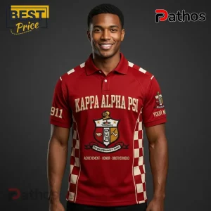 Man wearing crimson red Kappa Alpha Psi polo shirt with gold crest, side checkered patterns, and Greek lettering details.!