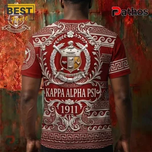 Kappa Alpha Psi red t-shirt with 3D white crest, scrollwork, Greek key patterns, and the year 1911 on a rustic background.!