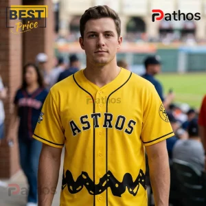 Houston Astros x Peanuts Snoopy Limited Edition Baseball Jersey 1 Man wearing a yellow Houston Astros baseball jersey with black Charlie Brown zig-zag trim on the bottom hem.!