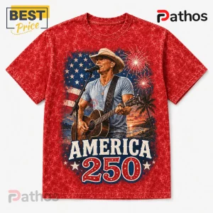 Kenny Chesney America 250 Limited Edition Graphic T-Shirt 2 Red acid-wash t-shirt featuring a country singer with guitar, US flag background, fireworks, and America 250 printed text.!