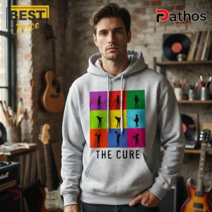 Man wearing a grey hoodie featuring a colorful pop-art grid of silhouette musicians and The Cure band text logo.!