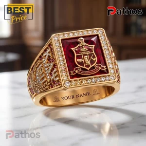 Kappa Alpha Psi Gold Ruby Crest Ring 1 Gold fraternity ring featuring a large rectangular red stone with a Greek shield emblem and diamond accents on a marble base.!