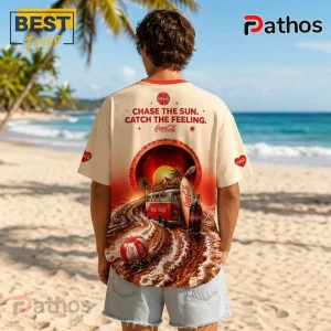 Cream t-shirt showing a red Coca-Cola bottle cap graphic with a beach van, surfboard, and text on a tropical beach background.!