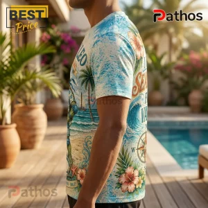 Teenage Mutant Ninja Turtles Leonardo Tropical T-Shirt 2 Man wearing a light blue tropical print t-shirt featuring palm trees, hibiscus flowers, ocean waves, and a compass design.!