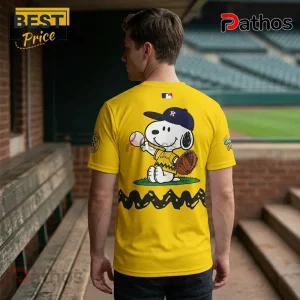 Snoopy x Houston Astros MLB Peanuts Night Collectible T-Shirt 3 Yellow Houston Astros baseball t-shirt featuring Snoopy wearing a team hat and holding a baseball with a zigzag pattern.!