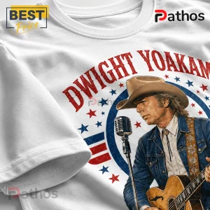 White t-shirt featuring a Dwight Yoakam graphic, with red text, blue stars, and a country singer illustration.!