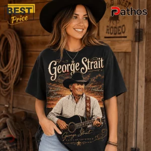 Woman wearing black graphic t-shirt featuring George Strait with guitar, sunset background, and country western text design.!