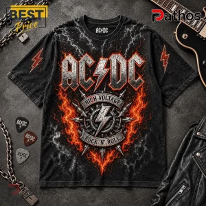 ACDC High Voltage Rock N Roll Band Black T-Shirt 1 AC/DC band t-shirt with High Voltage graphic, red fire, lightning bolts, and metal studs on a black cotton crewneck.!