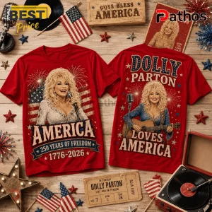 Dolly Parton x USA 250 Years of Freedom Anniversary T-Shirt 1 Two red cotton t-shirts featuring Dolly Parton graphics with American flags, fireworks, and text celebrating 1776-2026.!