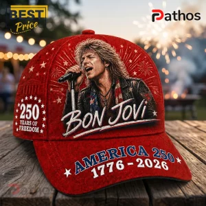 Red baseball cap featuring a portrait of Jon Bon Jovi, fireworks, stars, and text reading America 250 1776-2026.!