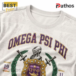 Omega Psi Phi Fraternity 1911 Heritage Crest Mascot T-Shirt 1 Omega Psi Phi t-shirt in cream featuring purple varsity lettering, a metallic gold shield crest, helmet, and swords.!