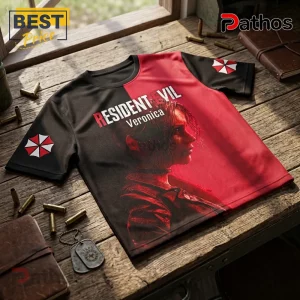 Resident Evil Code Veronica Red Black T-Shirt 1 Resident Evil Code Veronica t-shirt with red and black split design, Umbrella Corporation logos on sleeves, on wood table.!