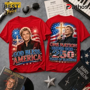 Red cotton t-shirts with Barry Manilow portrait, American flag, cross, and God Bless America text on gray background.!