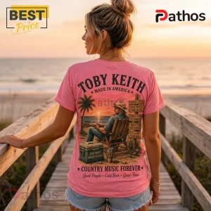 Pink t-shirt with Toby Keith graphics featuring a cowboy sitting by the beach, text lyrics, and a wooden signpost.!