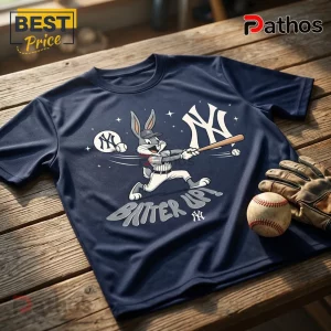 Looney Tunes x New York Yankees Navy Blue T-Shirt 1 Navy blue t-shirt with Bugs Bunny swinging a baseball bat, New York Yankees logos, and the text Batter Up on wood table.!