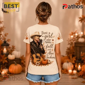 Alan Jackson Fall Pumpkin T-Shirt featuring a country singer graphic, autumn leaves, and text on a beige cotton background.