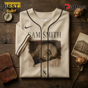 Sam Smith To Be Free Beige Baseball Jersey 2026 1 Beige baseball jersey featuring a photographic print of Sam Smith, a Nike swoosh, and SS monogram on wooden background.!