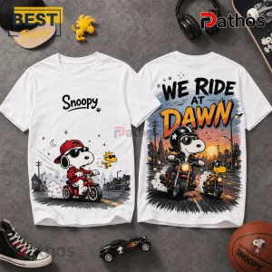 2026 Snoopy We Ride At Dawn Biker T-Shirt 6 White t-shirts featuring Snoopy and Woodstock riding motorcycles with the text We Ride At Dawn printed on the back.!