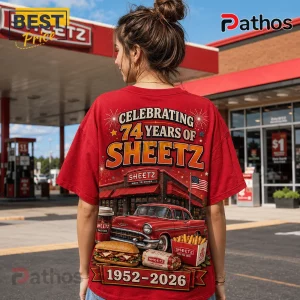 Sheetz 74th Anniversary 1952-2026 Red T-Shirt 4 Woman wearing red t-shirt with Sheetz 74th anniversary graphic, classic car, food, and American flag at gas station.!