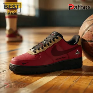 Custom red and tan basketball sneaker with ACES logo on tongue and side panel, resting on a wooden indoor court.!