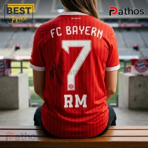 BTS x Bayern Munich RM 7 Red Football Jersey 3 Red FC Bayern Munich soccer jersey with number 7, white lettering, and a black autograph on the back, worn by a person.!