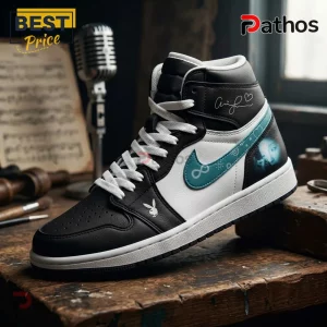 Ariana Grande Eternal Sunshine Tour Black Teal Air Jordan 1 2 Ariana Grande Eternal Sunshine Tour Black Teal Air Jordan 1 sneaker featuring side portrait art and infinity symbol logo.