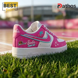 Premium Barbie x Phoenix Mercury Air Force 1 Sneakers 1 Premium Barbie x Phoenix Mercury Air Force 1 Sneakers in pink and white with basketball-themed branding on green grass.