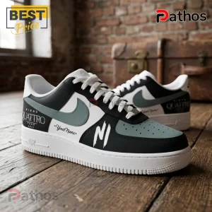 Customized white, black, and sage green sneakers with Ninho Quattro Tour 2027 branding and custom name text on wooden floor.!