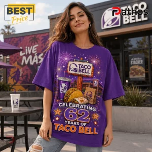 Taco Bell Vintage 62 Years Anniversary T-Shirt 3 Woman wearing a purple oversized T-shirt featuring a 62nd anniversary Taco Bell graphic with fireworks and food items.!
