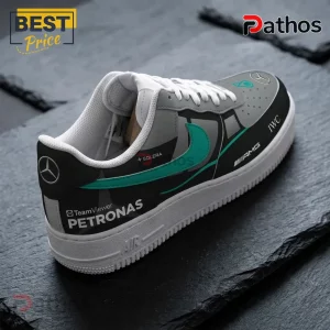 Mercedes AMG Petronas F1 Team Black Grey Air Force 1 Sneakers 1 Mercedes-AMG Petronas F1 themed sneaker in gray and black with teal accents and sponsor logos on a stone surface.!
