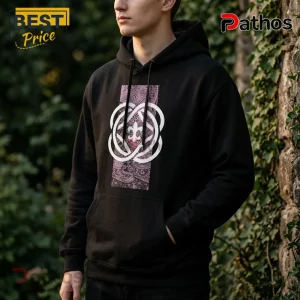 Black hooded sweatshirt with a centered rectangular graphic featuring a white clover motif over a purple paisley background.!