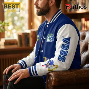 Man wearing a blue and white Sonic the Hedgehog 35th anniversary varsity jacket with Sega logo and character patches.!
