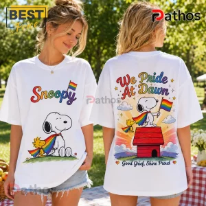 White t-shirt showing front graphic Snoopy with rainbow cape and back graphic Snoopy with Woodstock on a red doghouse.!