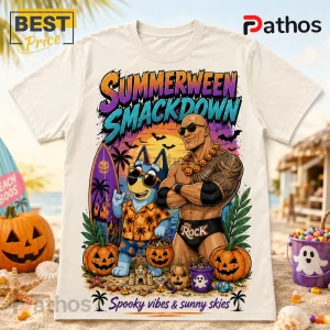 The Rock x Bluey Summerween Beige T-Shirt featuring Dwayne Johnson and a blue dog character on a tropical beach at sunset.
