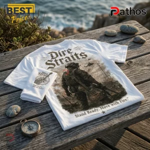 Dire Straits Military Theme White T-Shirt 1 White t-shirt featuring Dire Straits band logo, soldier with guitar, and text Stand Ready, Move with Fire on wooden deck.!