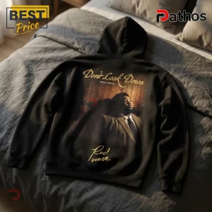 Black hooded sweatshirt featuring a printed graphic of Rod Wave with the text Don't Look Down on a wooden background.!