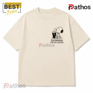 Guinness x Snoopy Vintage Cream T-Shirt 2 Beige cotton t-shirt with a chest graphic of Snoopy sitting next to a glass of Guinness beer and the text Dark Pour, Good Roar.!