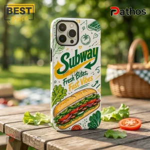 Subway branded iPhone case with sandwich illustration, Fresh Bites, Fast Vibes text, on a wooden outdoor picnic table.!
