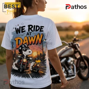 2026 Snoopy We Ride At Dawn Biker T-Shirt 2 White t-shirt showing Snoopy and Woodstock riding motorcycles at sunrise with text reading We Ride At Dawn.!