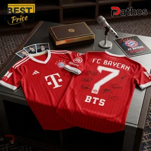BTS x Bayern Munich Arirang Red Football Jersey 1 Red FC Bayern Munich football jersey with BTS logo and number 7, featuring digital autographs on a wooden table.!