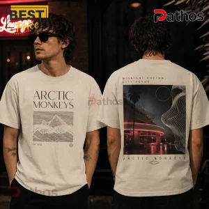 Arctic Monkeys Midnight Rhythm T-Shirt 2 Arctic Monkeys graphic t-shirt in cream featuring line art mountain on front and night city skyline print on back.!