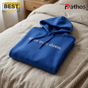 Caitlin Clark 2026 Special Edition Blue Hoodie 2 Royal blue cotton hoodie with white text reading Shoot more threes on a beige linen bedspread.!