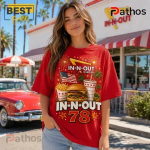 Woman wearing red t-shirt with In-N-Out Burger graphics including double cheeseburger, fries, drink, flag, and the number 78.!