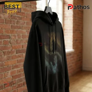 Black hoodie with Sam Smith graphic print featuring reaching hands on a hanger against a blurred red brick wall.!