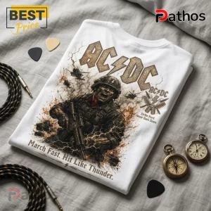 White cotton t-shirt featuring AC/DC logo, screaming soldier, helicopters, and text March Fast. Hit Like Thunder.!