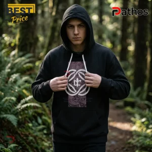 Man wearing a black cotton hooded sweatshirt with a central white geometric logo and paisley print patch in a forest.!