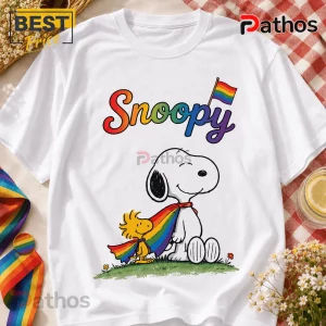 Snoopy Pride Rainbow LGBTQ T-Shirt 2026 5 White crewneck t-shirt featuring Snoopy and Woodstock wearing a shared rainbow pride cape with colorful Snoopy text.!