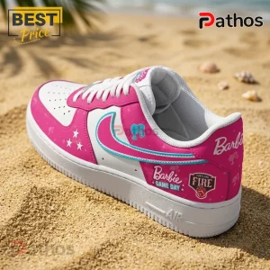 Barbie x Portland Fire WNBA 2026 Custom Air Force 1 1 Barbie x Portland Fire WNBA 2026 Custom Air Force 1 sneaker in pink and white with turquoise swoosh on a sandy beach.