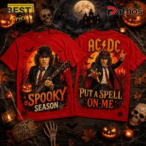 AC/DC Spooky Season Halloween red t-shirt showing Angus Young with a guitar and text over a dark haunted house background.